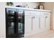 Built-in bar area features marble countertops, modern cabinets, and mini-fridge at 29348 N Clear Ridge Rd, Rio Verde, AZ 85263