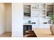 Contemporary bar area with wine rack, shelving, beverage refrigerator and table with two chairs at 29348 N Clear Ridge Rd, Rio Verde, AZ 85263