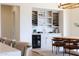 Bar area with a built-in wine rack and mini fridge nestled into modern cabinets at 29348 N Clear Ridge Rd, Rio Verde, AZ 85263