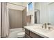 Light bathroom with a tiled wall, a shower and tub combo and single sink vanity at 29348 N Clear Ridge Rd, Rio Verde, AZ 85263