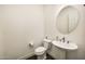 Bright powder bathroom featuring a pedestal sink and a round mirror at 29348 N Clear Ridge Rd, Rio Verde, AZ 85263