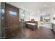 Spacious bathroom featuring glass-enclosed shower, soaking tub and a view into bedroom at 29348 N Clear Ridge Rd, Rio Verde, AZ 85263