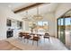 Bright dining room featuring modern light fixtures, wood accents, and sliding doors to the backyard at 29348 N Clear Ridge Rd, Rio Verde, AZ 85263