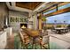 Chic dining room with a long wooden table, fireplace, and seamless indoor-outdoor living space at 29348 N Clear Ridge Rd, Rio Verde, AZ 85263