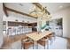 Open concept kitchen and dining area with bar, modern lighting, and natural light at 29348 N Clear Ridge Rd, Rio Verde, AZ 85263