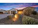 Charming single-story home with desert landscaping and a warm, inviting entrance at twilight at 29348 N Clear Ridge Rd, Rio Verde, AZ 85263