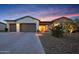 Inviting home with a lush desert landscape, illuminated entry, and a spacious driveway at 29348 N Clear Ridge Rd, Rio Verde, AZ 85263