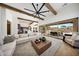 Spacious living room with exposed beams, fan, and sliding glass doors to the patio and pool at 29348 N Clear Ridge Rd, Rio Verde, AZ 85263