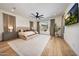 Spacious primary bedroom featuring a modern ceiling fan, a large window, and neutral decor at 29348 N Clear Ridge Rd, Rio Verde, AZ 85263