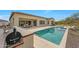 Relaxing backyard with a refreshing pool, spa, outdoor kitchen, and a covered patio at 29348 N Clear Ridge Rd, Rio Verde, AZ 85263