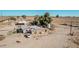 Aerial view of a single story house, highlighting the property's rural landscape and mature trees at 3279 E Selma Hwy, Casa Grande, AZ 85194