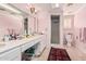 Bright bathroom with double vanity, a walk-in shower, and pink walls at 3279 E Selma Hwy, Casa Grande, AZ 85194