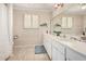 Well-lit bathroom with a dual sink vanity, neutral tile, and large mirror at 3279 E Selma Hwy, Casa Grande, AZ 85194