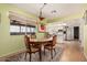 Bright dining room with a stylish chandelier, large window, and a view of the exterior at 3279 E Selma Hwy, Casa Grande, AZ 85194