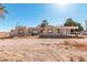 Image displays the exterior of the home featuring its facade, windows, and surrounding landscape at 3279 E Selma Hwy, Casa Grande, AZ 85194