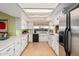 Efficient kitchen with bright white cabinetry, stainless steel refrigerator, and ample counter space at 3279 E Selma Hwy, Casa Grande, AZ 85194