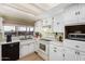 Functional kitchen featuring white appliances, ample counter space, and bright, overhead lighting at 3279 E Selma Hwy, Casa Grande, AZ 85194