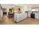 Open kitchen layout with white countertops and cabinetry, adjoining dining space, and modern appliances at 3279 E Selma Hwy, Casa Grande, AZ 85194