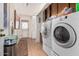 Functional laundry room with cabinetry, a white door, and a washer and dryer at 3279 E Selma Hwy, Casa Grande, AZ 85194