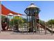 A vibrant community playground with interconnected play structures and shaded seating areas at 335 S Saint Augustine Ct, Casa Grande, AZ 85194