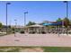 Community volleyball court with nearby shade pavilion and waterpark slides and splashes in the background at 335 S Saint Augustine Ct, Casa Grande, AZ 85194