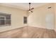 Bedroom with wood floors, neutral walls, window, and a ceiling fan at 3354 N 157Th Ave, Goodyear, AZ 85395