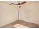 Bright bedroom featuring a ceiling fan and wood-look flooring at 3354 N 157Th Ave, Goodyear, AZ 85395