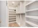 Walk-in closet with custom shelving and hardwood floors at 3354 N 157Th Ave, Goodyear, AZ 85395