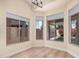 Dining room with hardwood floors, bright windows with blinds, and a modern chandelier at 3354 N 157Th Ave, Goodyear, AZ 85395