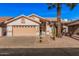 Inviting single-story home with desert landscaping, a two-car garage, and mature trees at 3354 N 157Th Ave, Goodyear, AZ 85395