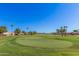 Well-manicured green with mature trees on golf course at 3354 N 157Th Ave, Goodyear, AZ 85395