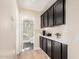 Hallway with dark cabinetry with gold pulls and view into bathroom at 3354 N 157Th Ave, Goodyear, AZ 85395