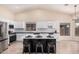 Modern kitchen with stainless appliances, seating at the island, and open layout at 3354 N 157Th Ave, Goodyear, AZ 85395