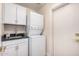 Well-lit laundry area with stacked washer/dryer and utility sink at 3354 N 157Th Ave, Goodyear, AZ 85395