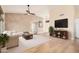 Bright living room showcases stylish wall decor, sleek entertainment center, and light, modern flooring at 3354 N 157Th Ave, Goodyear, AZ 85395