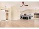 Open-concept living room with hardwood floors connected to the eat-in kitchen and ceiling fan at 3354 N 157Th Ave, Goodyear, AZ 85395