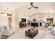 Open-concept living room features a modern kitchen, vaulted ceilings, and elegant decor for comfortable living at 3354 N 157Th Ave, Goodyear, AZ 85395