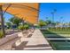 Shuffleboard courts, seating and covered area, with manicured landscaping at 3354 N 157Th Ave, Goodyear, AZ 85395