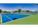 Bright blue tennis courts with green surroundings, perfect for recreational play and athletic activities at 3354 N 157Th Ave, Goodyear, AZ 85395