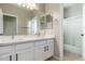 Bathroom featuring double sinks, white cabinets, and a shower with glass door at 3416 E Blue Ridge Pl, Chandler, AZ 85249