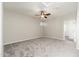 A carpeted bedroom with a ceiling fan and an open doorway at 3416 E Blue Ridge Pl, Chandler, AZ 85249