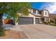 Wide driveway leading to a three-car garage, framed by mature landscaping at 3416 E Blue Ridge Pl, Chandler, AZ 85249