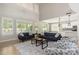 Bright living room featuring large windows, modern sofas and an open layout to the kitchen at 3416 E Blue Ridge Pl, Chandler, AZ 85249