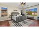 Spacious main bedroom featuring a ceiling fan, wood floors, a patterned rug, and sun-filled windows at 3416 E Blue Ridge Pl, Chandler, AZ 85249