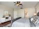 This main bedroom has a ceiling fan, wood floors, and a door leading to the bathroom at 3416 E Blue Ridge Pl, Chandler, AZ 85249