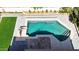 Aerial view of the sparkling backyard pool with a slide, stone patio, and artificial turf at 3416 E Blue Ridge Pl, Chandler, AZ 85249