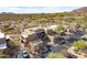 Scenic aerial view of desert community with mountains in background and neutral-toned building at 36601 N Mule Train Rd # D30, Carefree, AZ 85377