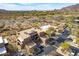 Wide aerial shot showing community condos, desert terrain, and a scenic mountain backdrop at 36601 N Mule Train Rd # D30, Carefree, AZ 85377