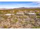 Expansive aerial shot of community featuring desert landscapes, architectural design, and mountain backdrop at 36601 N Mule Train Rd # D30, Carefree, AZ 85377