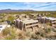 Aerial view of desert condos showcasing natural landscaping and mountain views in the background at 36601 N Mule Train Rd # D30, Carefree, AZ 85377